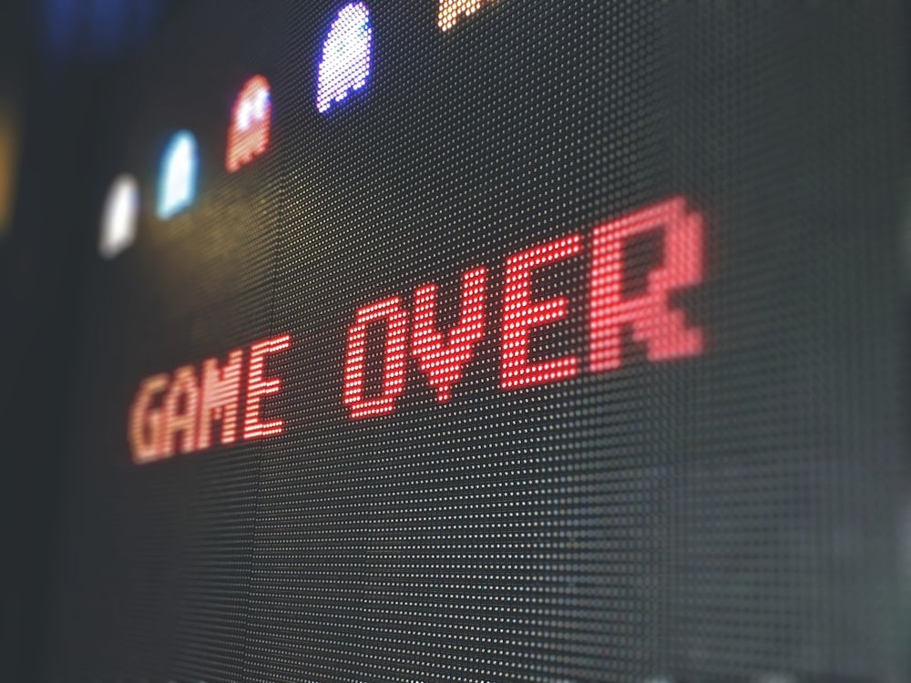 Pixelated Game Over screen on an oversized PAC-MAN arcade machine